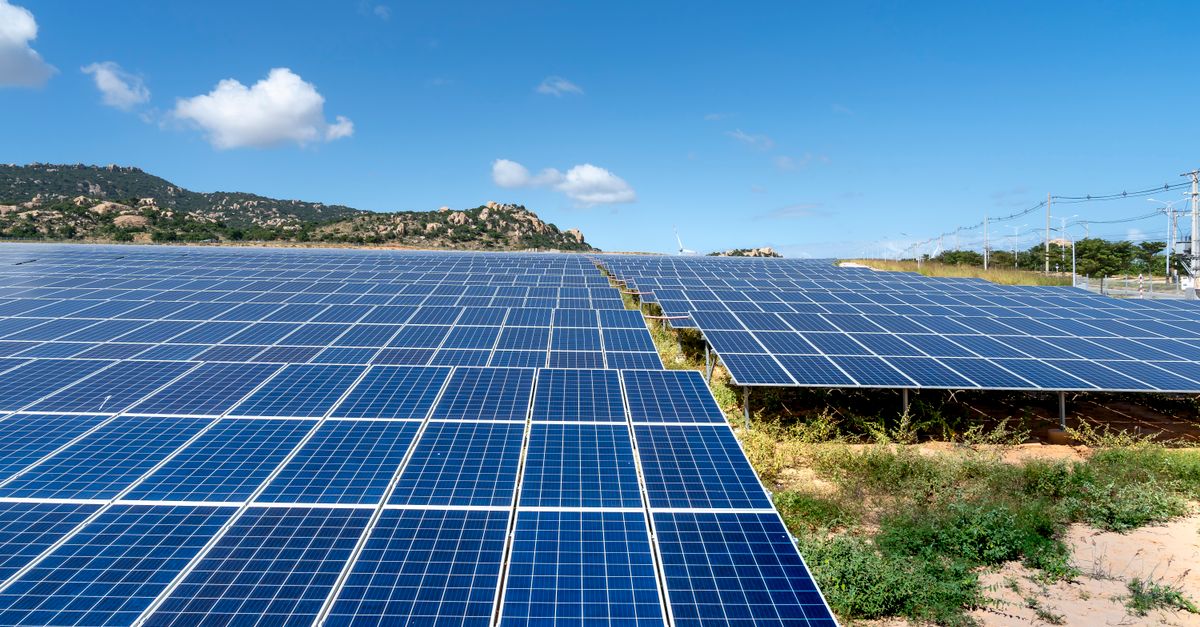 A vast field of solar panels harnessing solar energy on a sunny day.